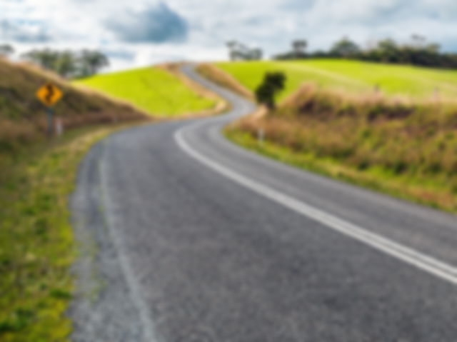 Winding road through Adelaide Hills farms during winter season, South Australia