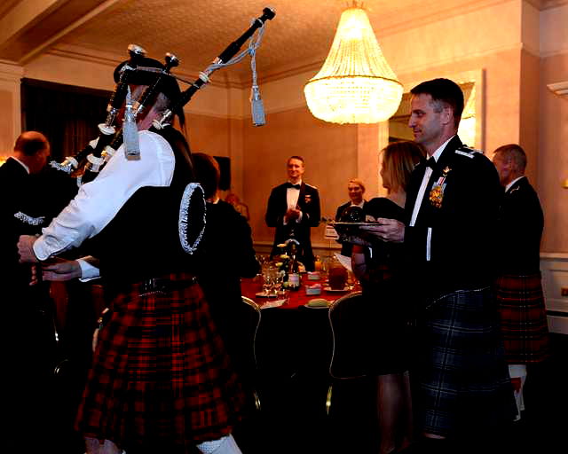 Men in Kilt celebrating burns night, haggis on the table