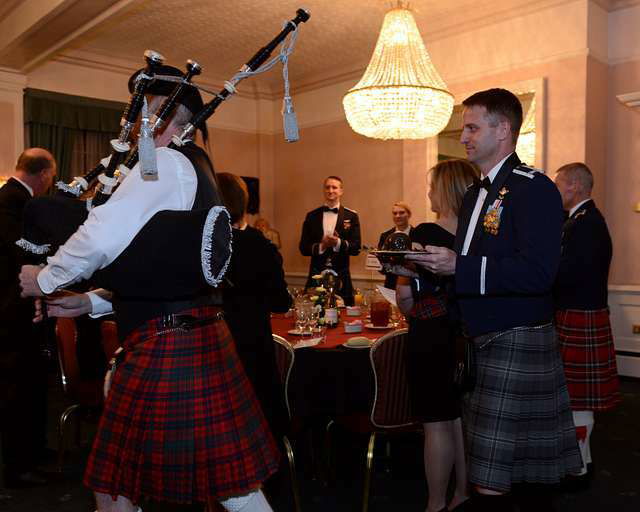 Men in Kilt celebrating burns night, haggis on the table