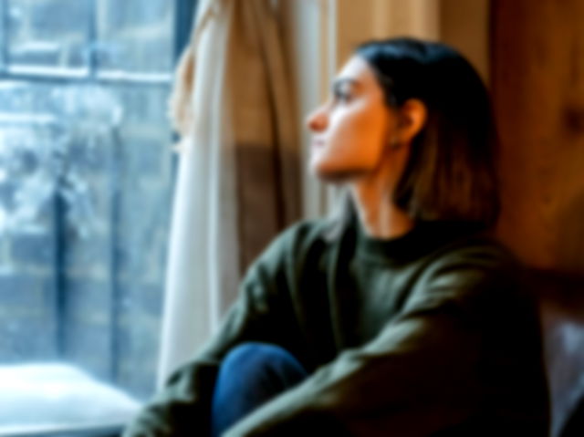 Woman staring blankly out of the window