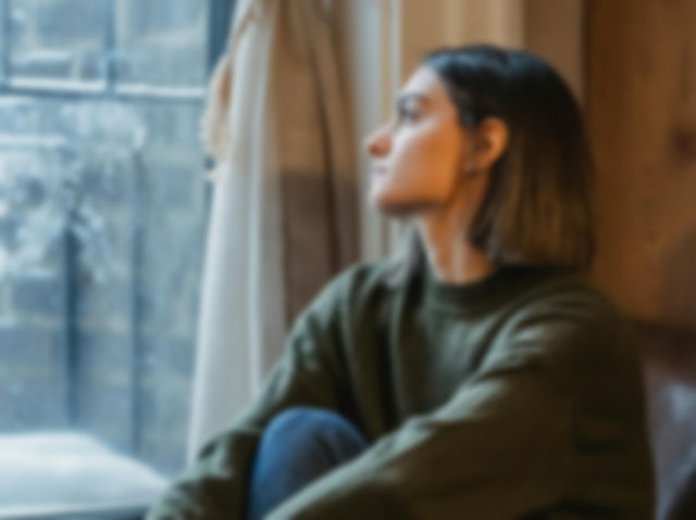 Woman staring blankly out of the window