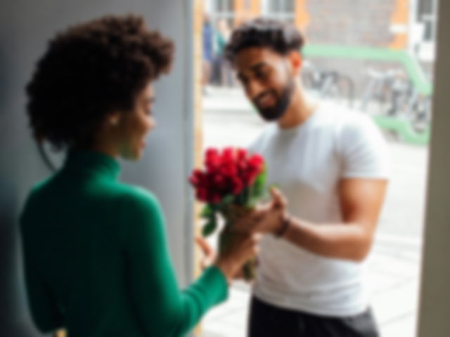 Man giving flowers to a woman