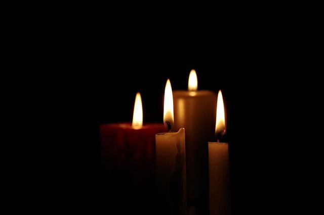 Four candles lighting up a dark room