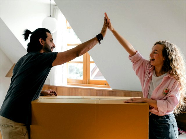 A man and woman high fiving each other