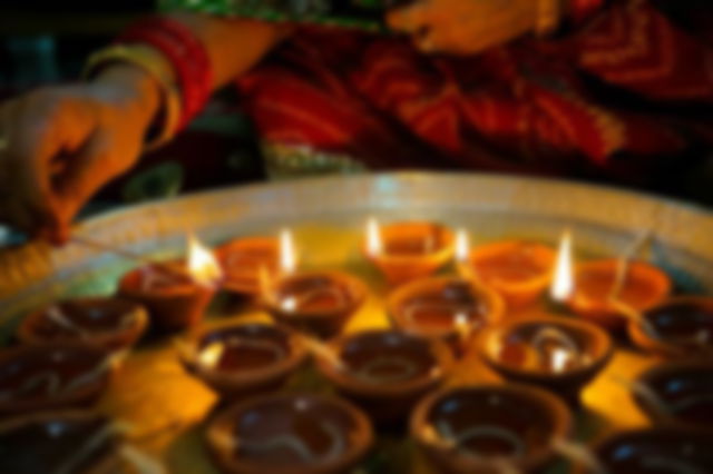 A woman lighting diyas