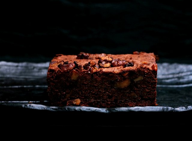 Chocolate brownie on a plate with a dark background