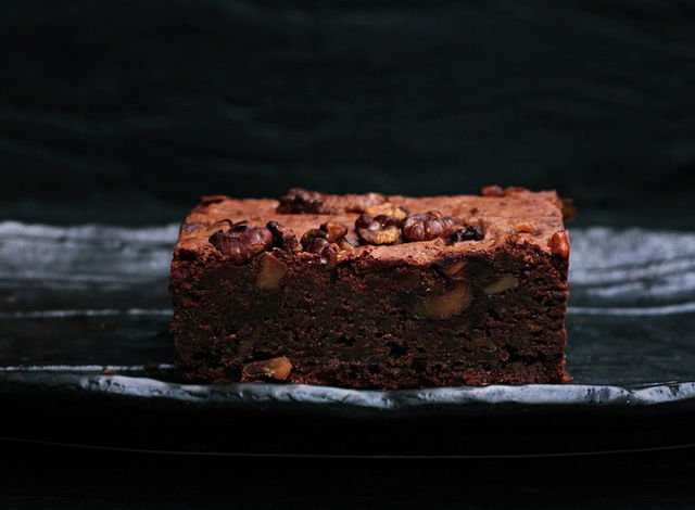 Chocolate brownie on a plate with a dark background