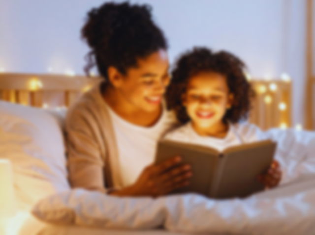 Día Mundial de la Lectura en Voz Alta: madre leyendo un cuento a su hija