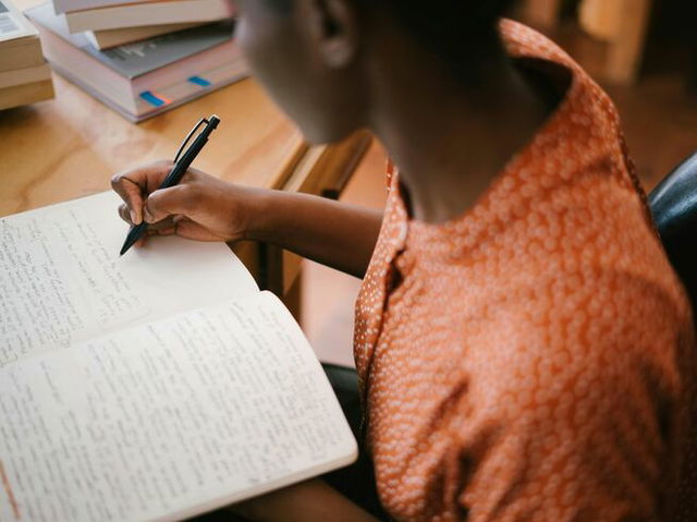 A woman writing an essay