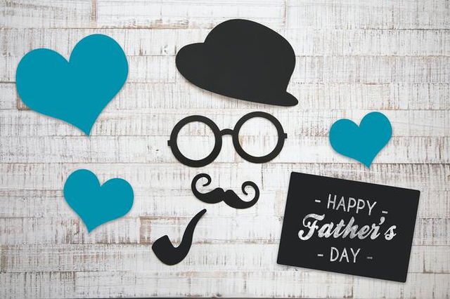 Fathers day message on gray background.  back hat, mustache, glasses and pipe, and blue hearts.