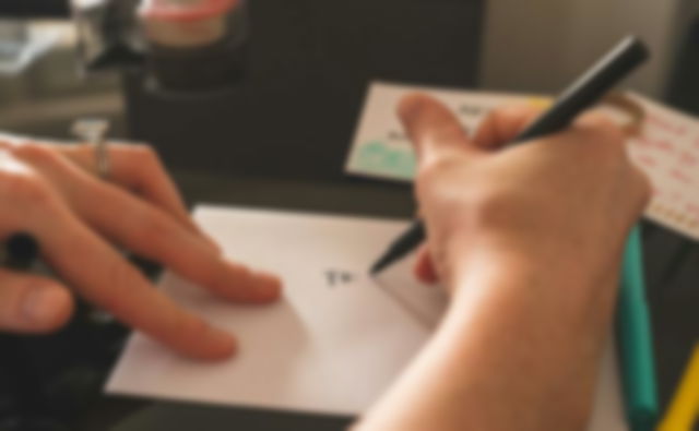 A person writing a letter