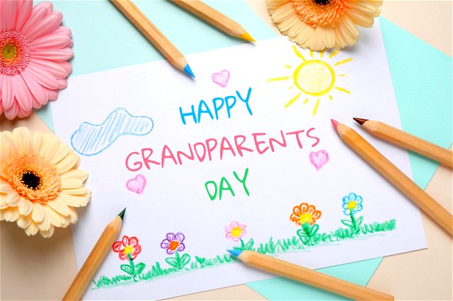 Handwritten message in crayon saying ‘happy grandparents day’ covered in doodles