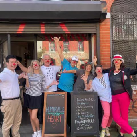 A red double-decker sightseeing bus labeled &ldquo;Big Bus New York&rdquo; parked along a busy city street, with pedestrians on the sidewalk and tall skyscrapers and digital billboards surrounding the scene.