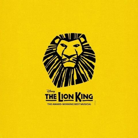 Yellow poster for Disney&rsquo;s The Lion King Broadway musical featuring a stylized black lion face logo and the show title below.
