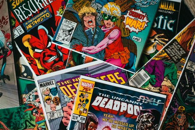A pile of comics, none completely in image. Colourful and bright. The words Marvel and Deadpool visible