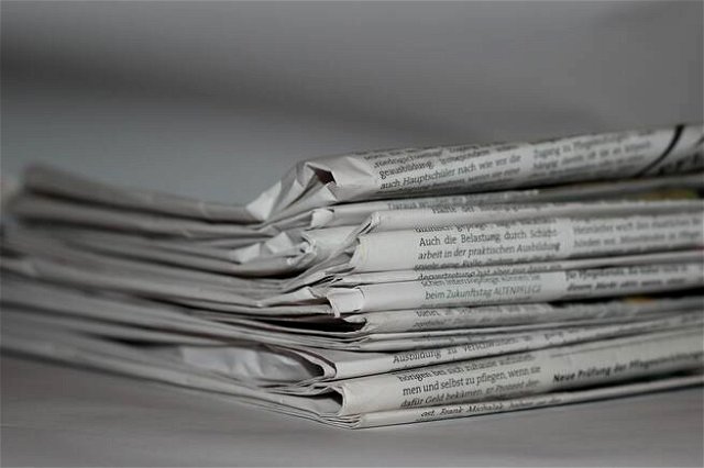 A pile of papers on a surface. A black and white image.