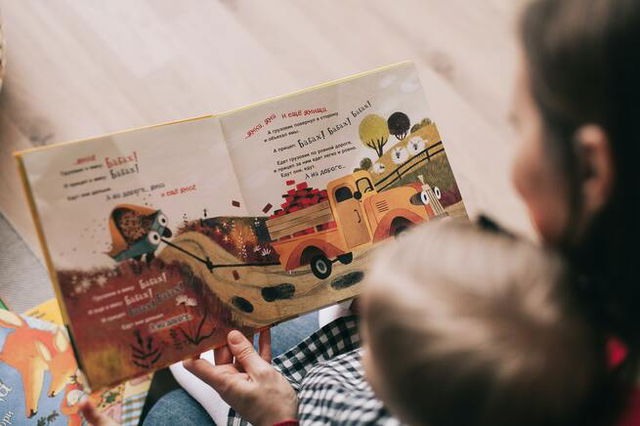 Child and parent reading a story together