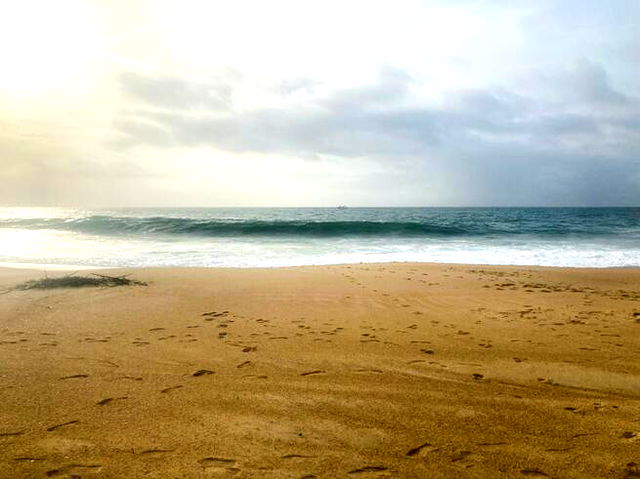 Yellow sand and the ocean waves coming into shore