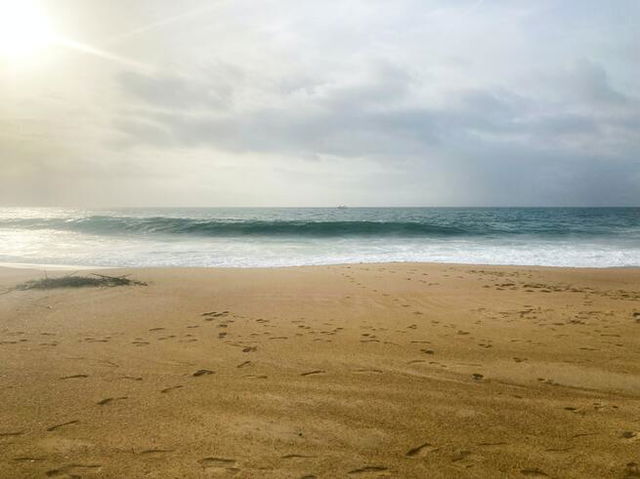 Yellow sand and the ocean waves coming into shore