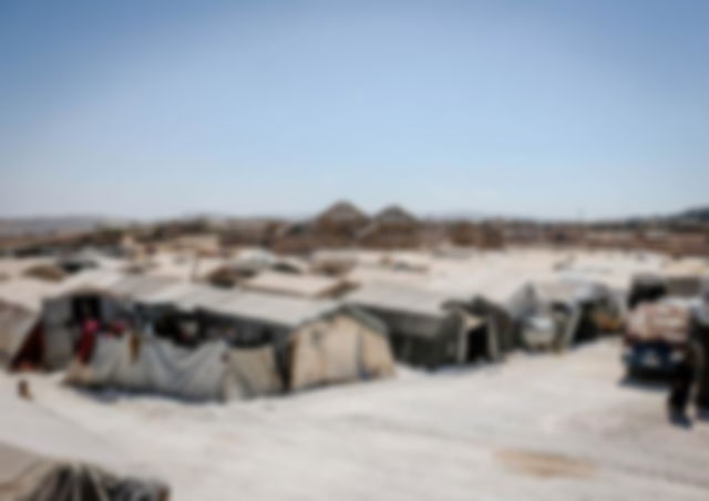 several temporary iron built constructions form a community under the hot sun and blue sky