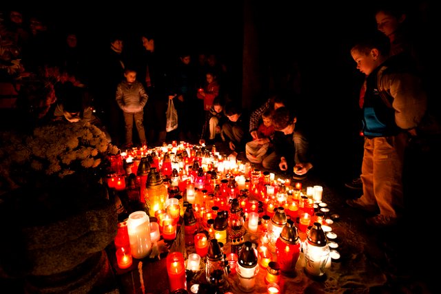 People lighting candles at the graveyard on All Soul‘s Day