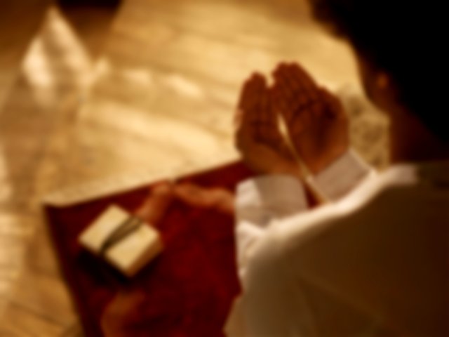 A Muslim man praying or making dua