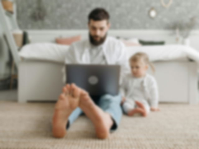 A man and his daughter looking at the laptop